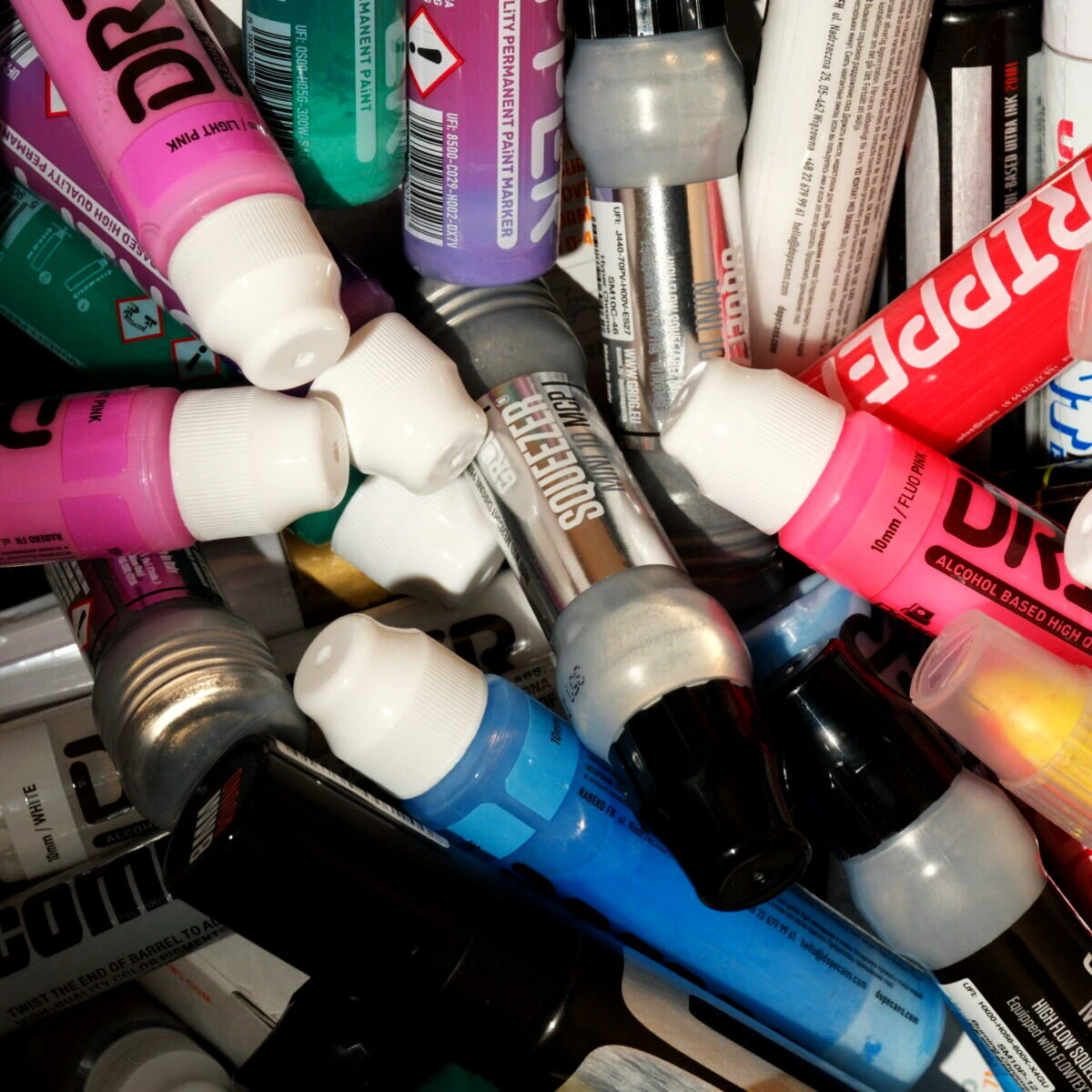 Bunte Paint Marker von Dripper, Squeezer und Grog durcheinander in einer Kiste